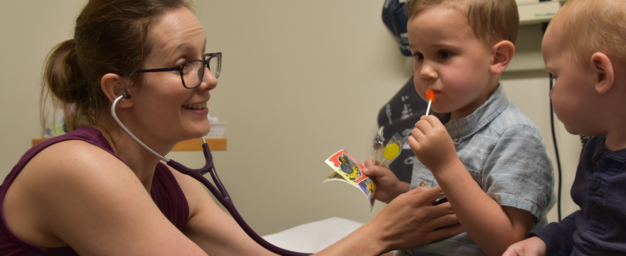 Dr. Meghan Chatwin checking up on children patients